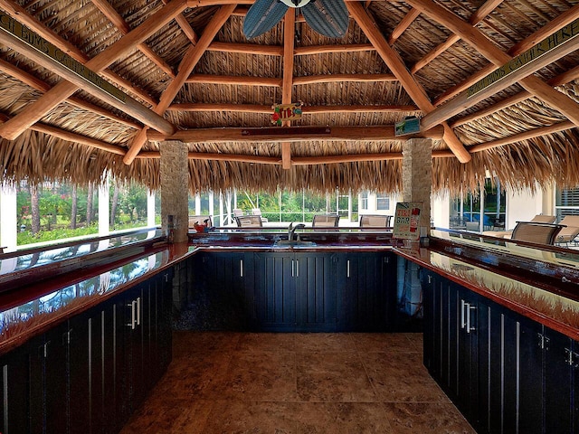 kitchen with dark countertops, a sink, and dark cabinets