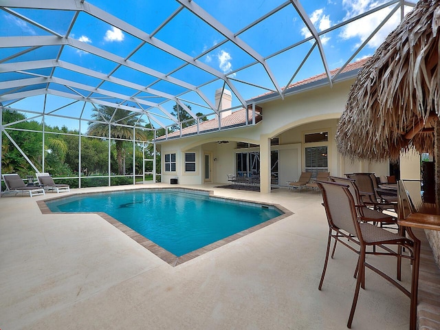 pool featuring a patio, a lanai, and a ceiling fan