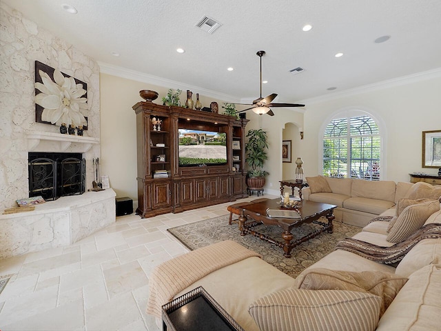 living area featuring visible vents, arched walkways, a high end fireplace, ceiling fan, and ornamental molding