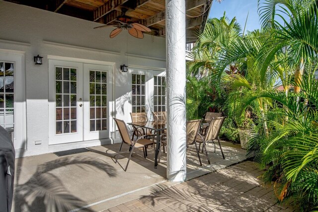 sunroom / solarium with ceiling fan, french doors, beamed ceiling, and wooden ceiling