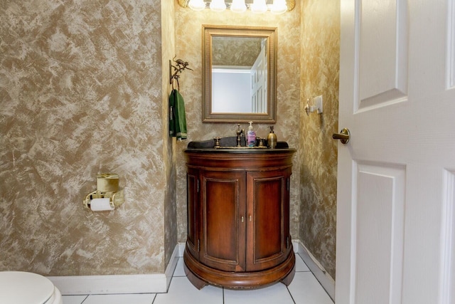 bathroom featuring toilet, vanity, and tile patterned flooring