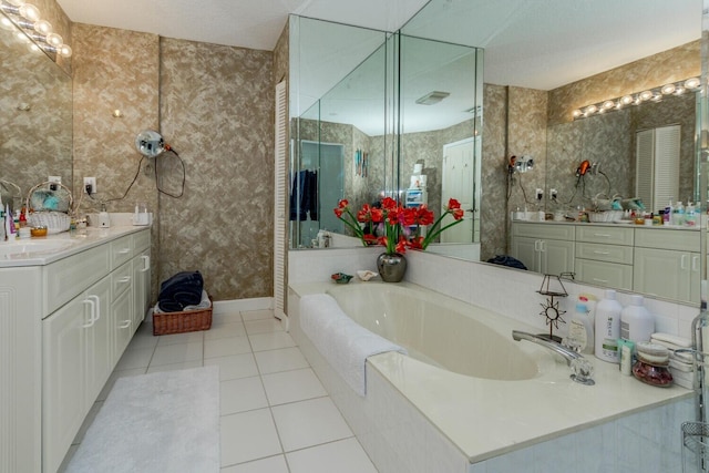 bathroom featuring tile patterned floors, vanity, and a bathing tub