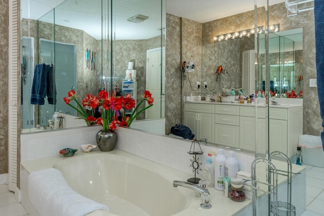 bathroom featuring a tub, tile patterned floors, and vanity