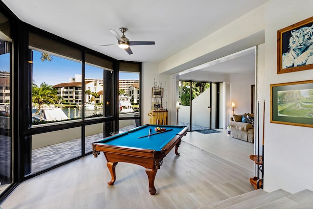 rec room with ceiling fan, floor to ceiling windows, light wood-type flooring, and billiards