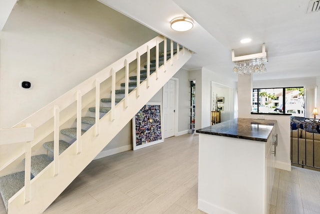 kitchen with white cabinets and an inviting chandelier