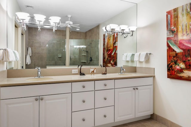 bathroom with tile patterned flooring, vanity, ceiling fan, and an enclosed shower