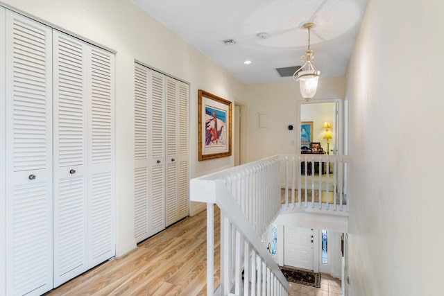 hallway with light hardwood / wood-style flooring