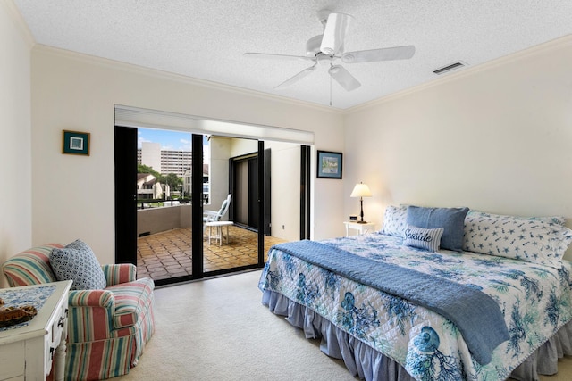 carpeted bedroom featuring a textured ceiling, ceiling fan, and crown molding