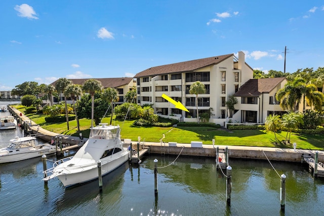 view of dock featuring a yard and a water view