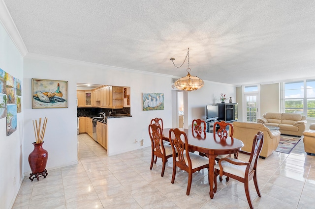 dining space with ornamental molding, a textured ceiling, and a chandelier