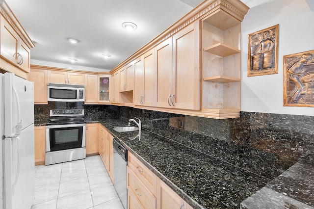 kitchen with light brown cabinets, stainless steel appliances, and sink