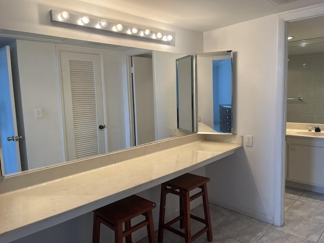 bathroom featuring tile patterned flooring and vanity