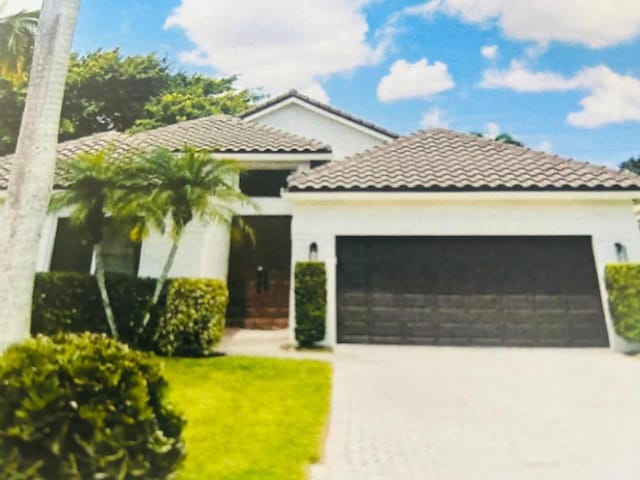 mediterranean / spanish house with a garage