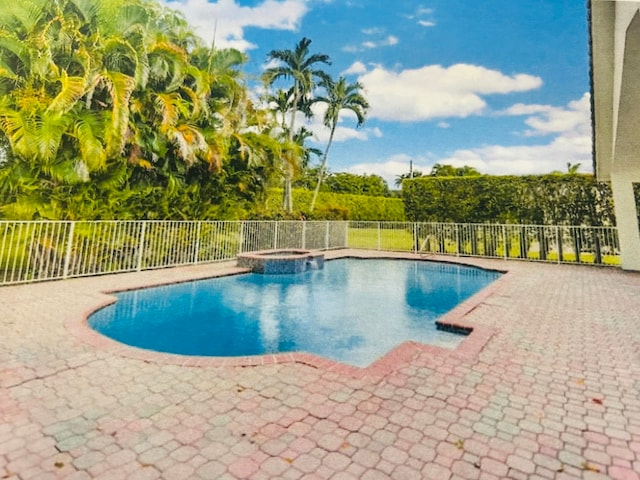 view of pool with a patio and an in ground hot tub