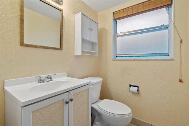 bathroom with toilet and vanity