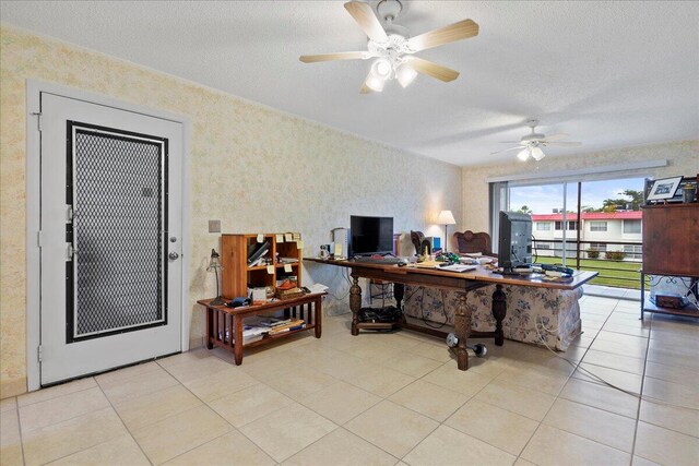 tiled office space featuring ceiling fan and a textured ceiling