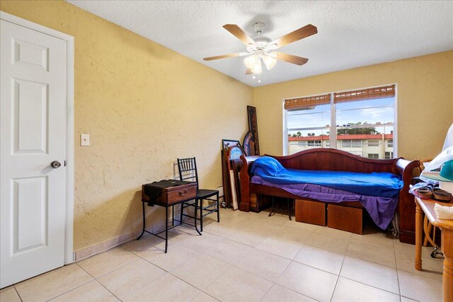 bedroom with a textured ceiling and ceiling fan