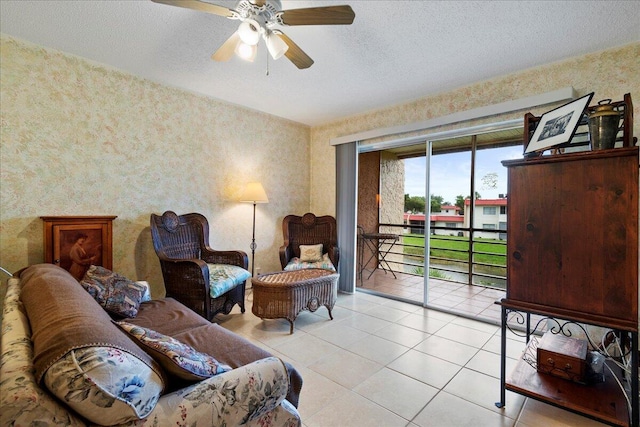 tiled living room with ceiling fan and a textured ceiling