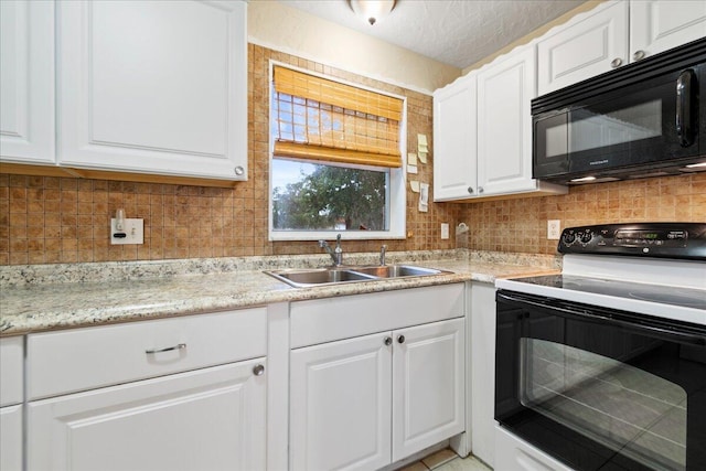 kitchen with black appliances, sink, and white cabinetry