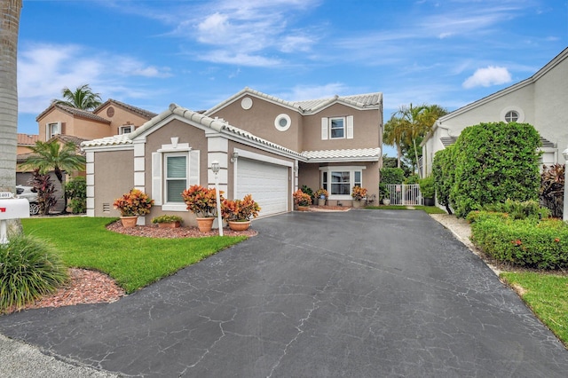 view of front of home with a front yard and a garage