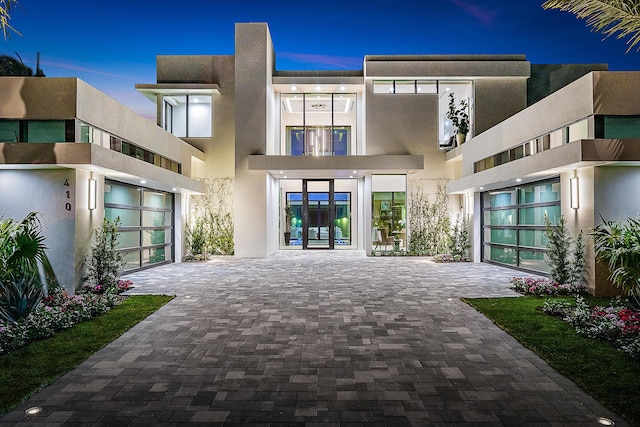 back house at dusk featuring french doors