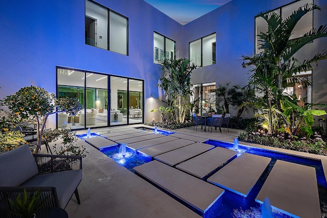 view of swimming pool with pool water feature