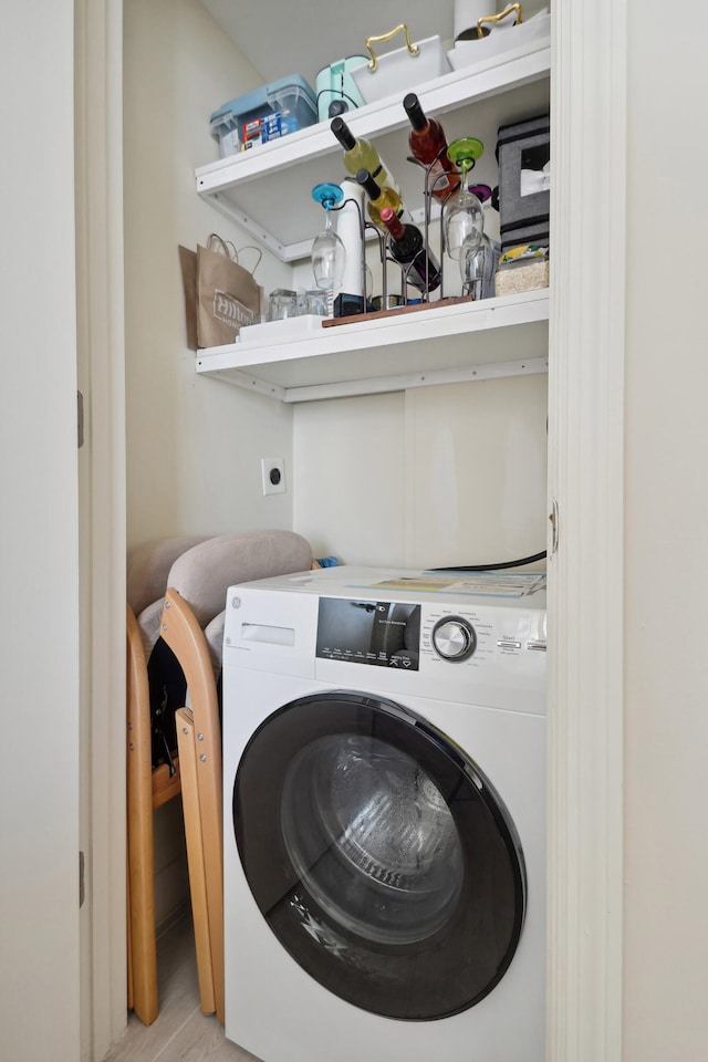 washroom with washer / dryer and light wood-type flooring