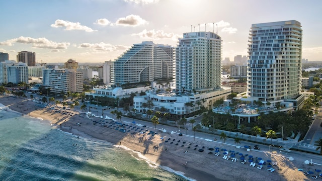 property's view of city featuring a water view and a view of the beach