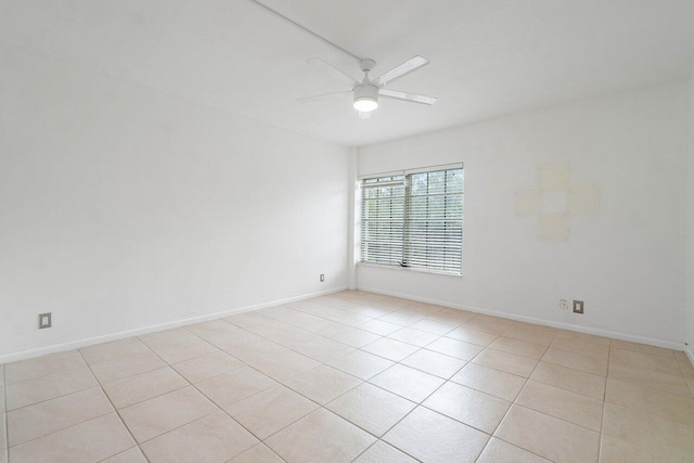 unfurnished room with light tile floors and ceiling fan