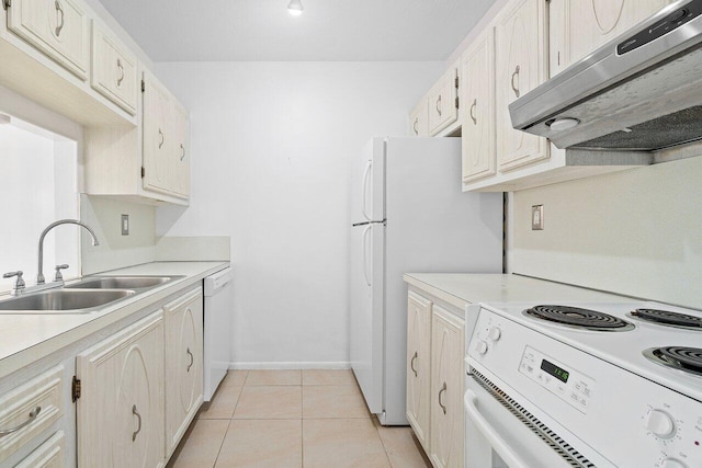 kitchen with light tile flooring, white appliances, and sink