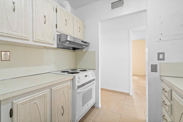 kitchen featuring light tile floors and white electric range