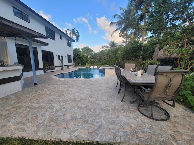 pool at dusk featuring a patio area