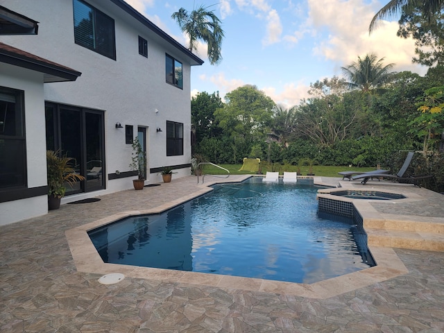 view of pool with an in ground hot tub and a patio