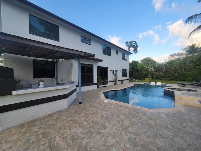 view of pool with an in ground hot tub and a patio area