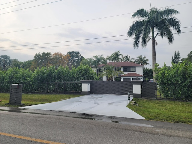 view of front of property featuring a garage and a front lawn