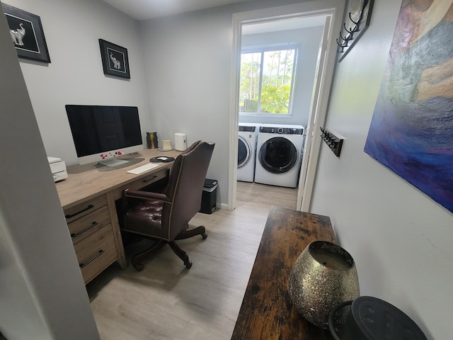 office with washing machine and clothes dryer and light hardwood / wood-style floors