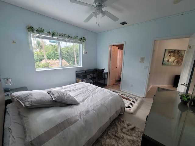 bedroom with light wood-type flooring and ceiling fan