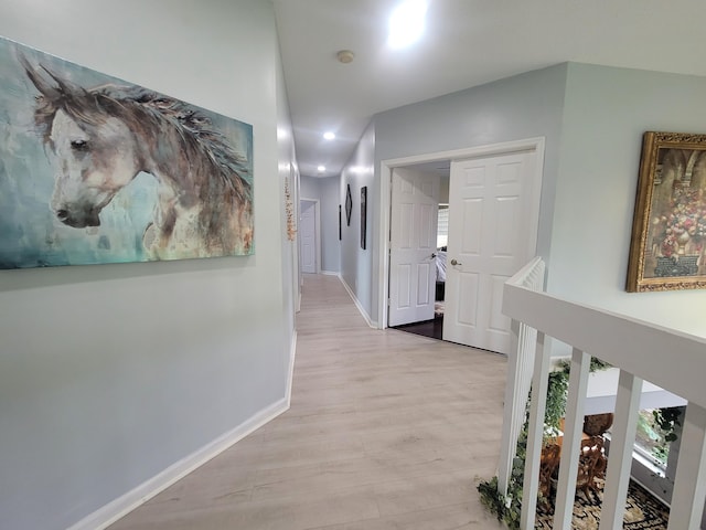 corridor with light hardwood / wood-style flooring