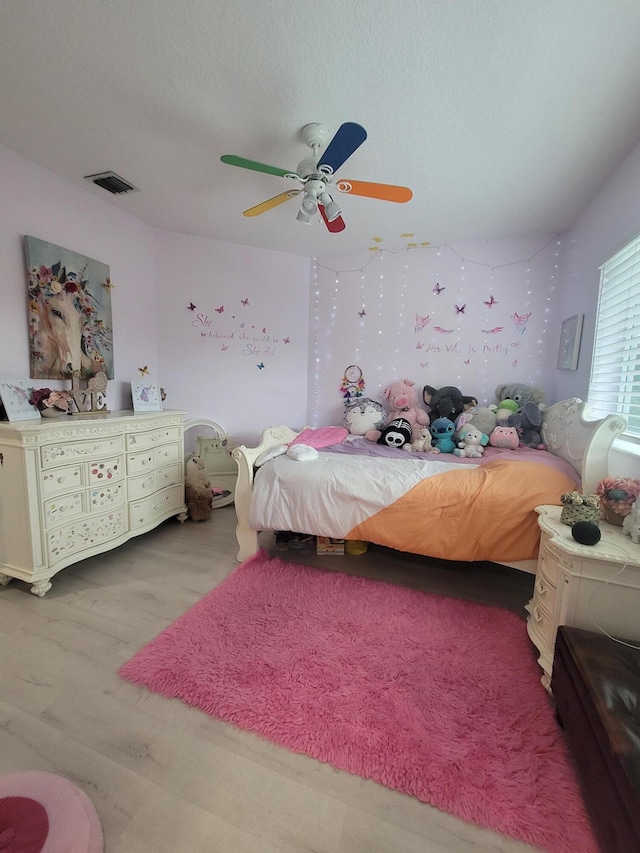 bedroom with light wood-type flooring and ceiling fan