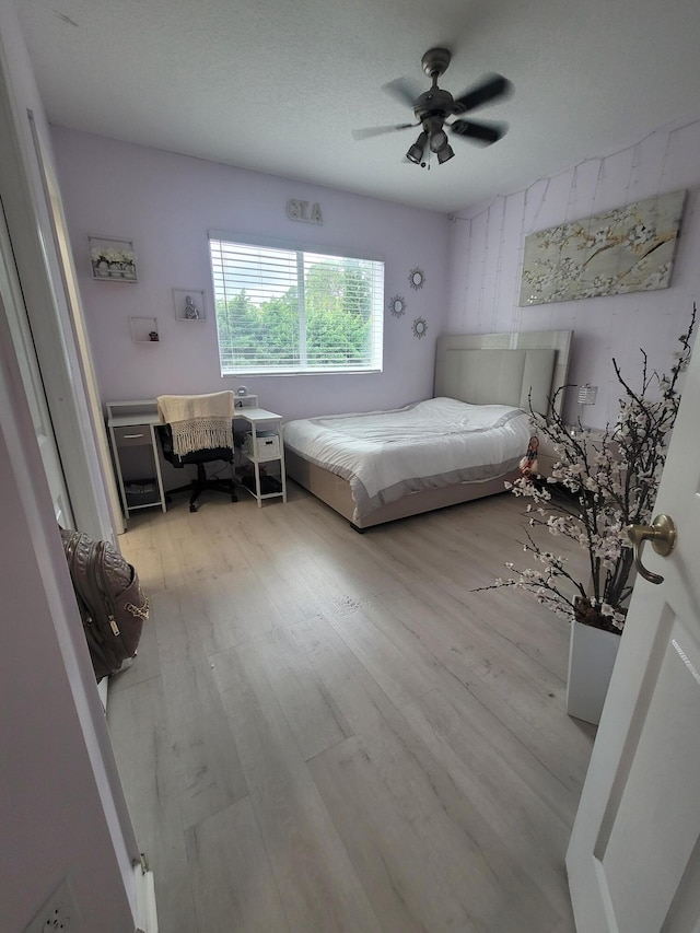 bedroom featuring ceiling fan and light hardwood / wood-style floors