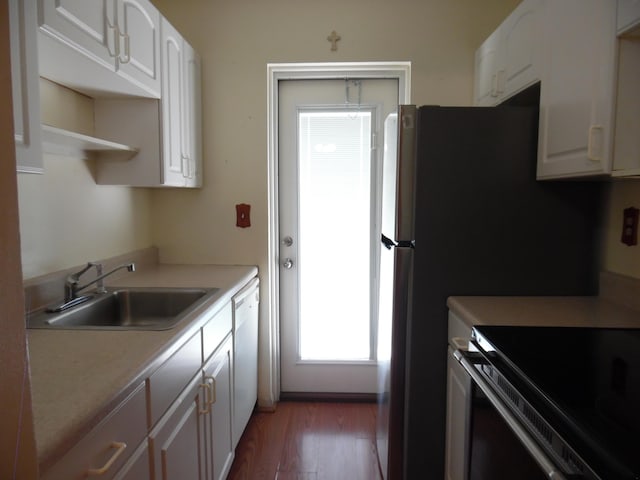 kitchen with white dishwasher, white cabinetry, dark hardwood / wood-style flooring, and sink