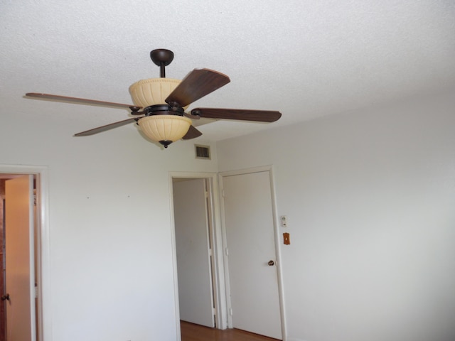 details with a textured ceiling and ceiling fan