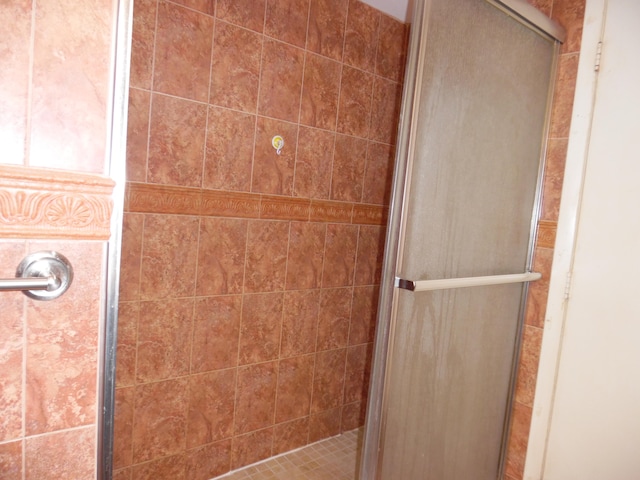 bathroom with a shower with door