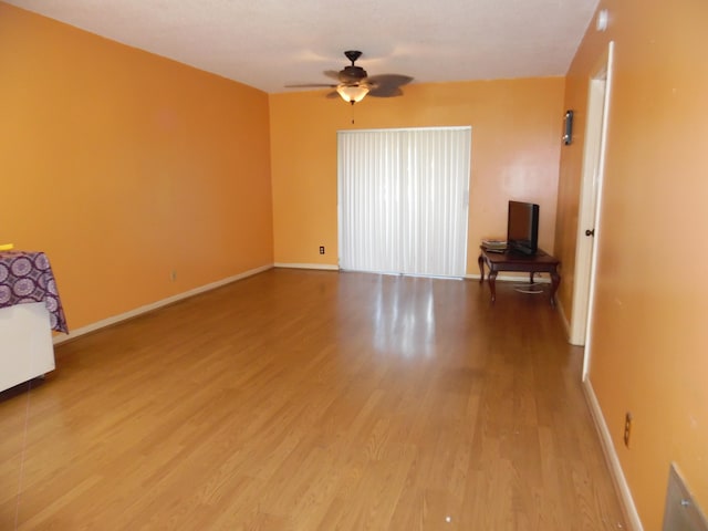 empty room with light hardwood / wood-style floors and ceiling fan