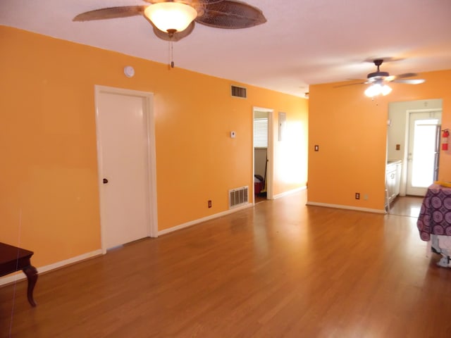 spare room with hardwood / wood-style floors and ceiling fan