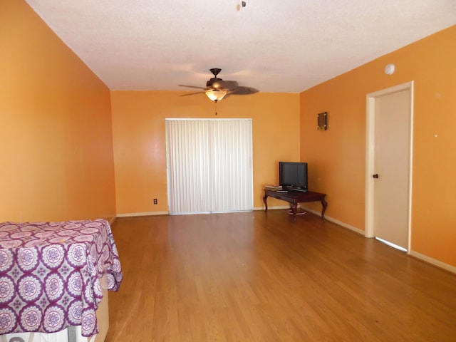 unfurnished bedroom with ceiling fan and dark hardwood / wood-style flooring