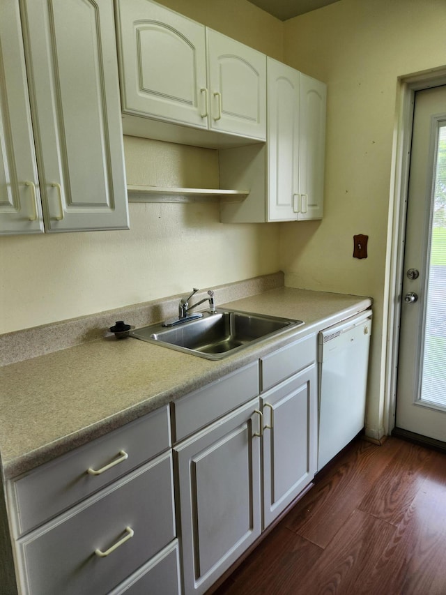 kitchen featuring dark hardwood / wood-style floors, white cabinets, dishwasher, and sink