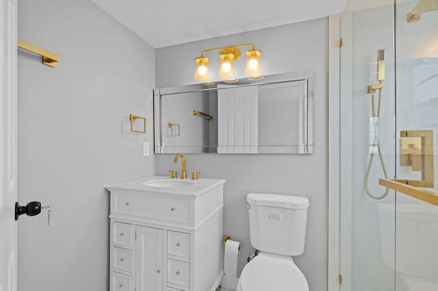 bathroom with vanity, toilet, and walk in shower