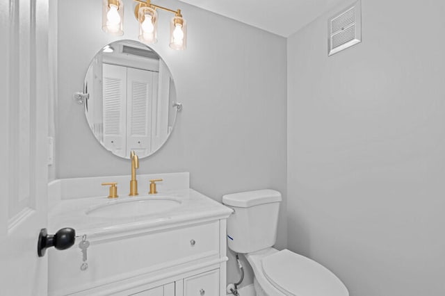 bathroom featuring toilet and vanity