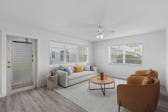 living room with light wood-type flooring and ceiling fan